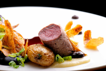 Haute cuisine, grilled Lamb steaks with a sauce of port, and potatoes