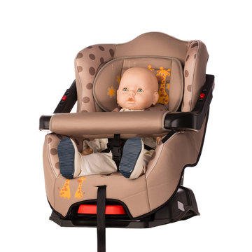 Baby doll in a booster seat for a car