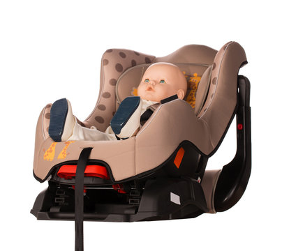 Baby doll in a booster seat for a car