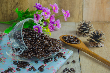 coffee beans with  cup on wood table