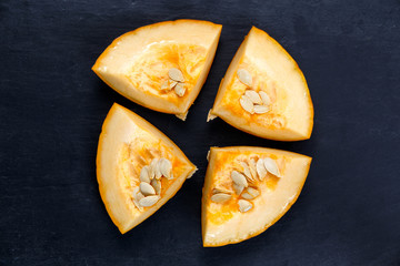 Fresh Pumpkin slices  on blue stone background