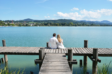 A couple on the wooden jetty at the lake. Switzerland