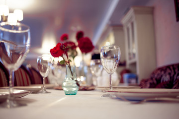 interior of the restaurant,  large table laid for  Banquet, decorated in Burgundy tones