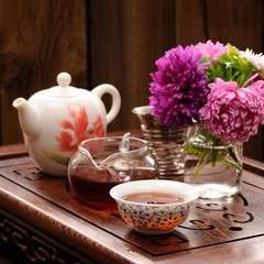 Bouquet of purple and pink asters and teaware for chinese tea ce
