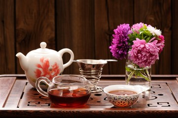 Bouquet of purple and pink asters and teaware for chinese tea ce