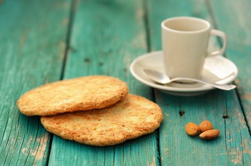 Empty cup for espresso, silver spoon, two homemade almond cookie