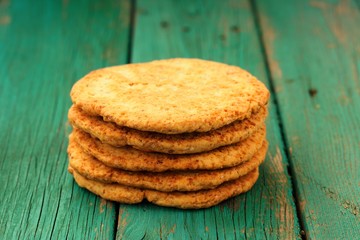 Yummy homemade almond cookies in pile on turquoise shabby backgr