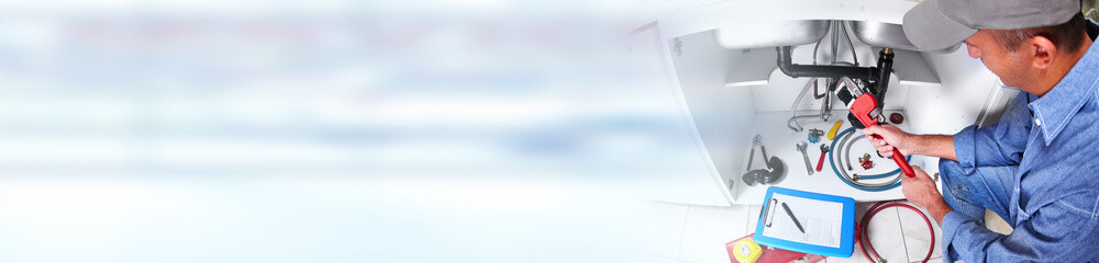 Hand of Plumber with a wrench.