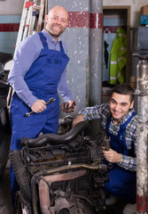 Fototapeta na wymiar car mechanics working at carshop