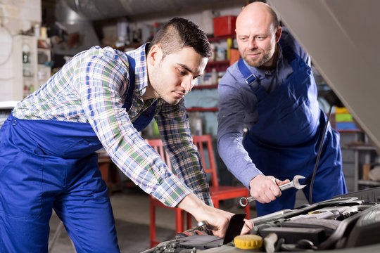 Mounting specialists in coveralls working