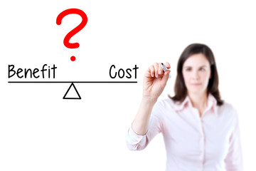 Young business woman writing cost and benefit compare on balance bar. Isolated on white background.