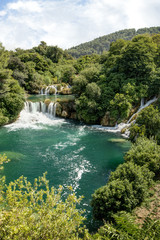 Scenic view of waterfalls, cascades and lush foliage at the Krka National Park in Croatia.