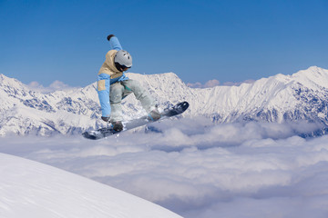 Flying snowboarder on mountains, extreme sport