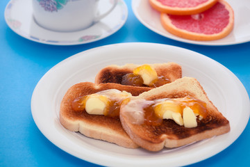 French toast with sliced orange on blue tablecloth