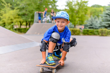 Small boy on his skateboard grinning at the camera © Daddy Cool