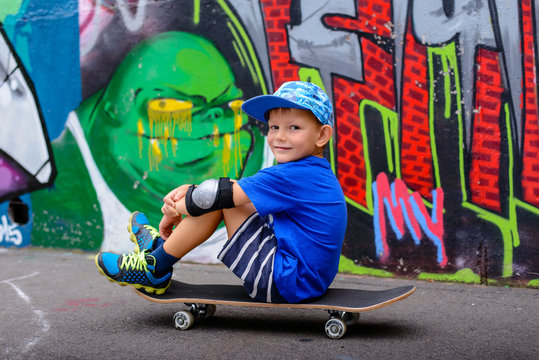 Young boy taking a rest at the skate park