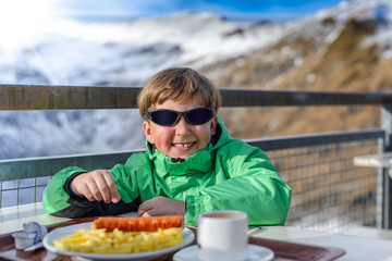 Obraz premium the boy has dinner at mountain restaurant