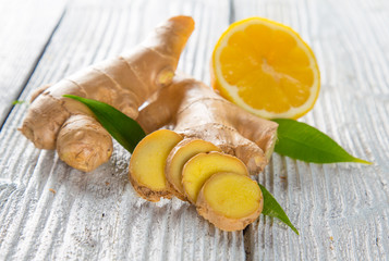 Fresh ginger root on wooden background.