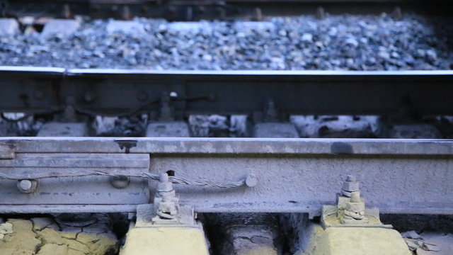 train wheels pressed rails and sleepers closeup