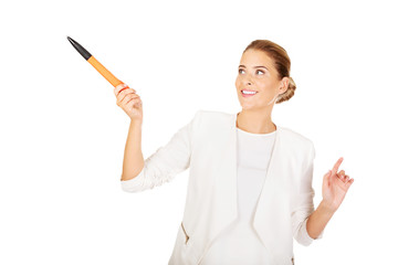 Young businesswoman points something big pen