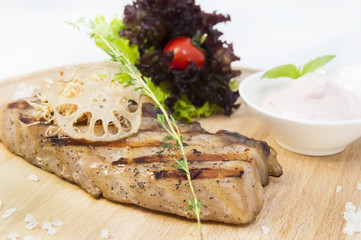 Catfish steak cooking on a grill in the restaurant