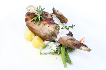 roasted rabbit meat and potatoes with vegetables