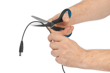 Obraz premium Hand with scissors and computer cable