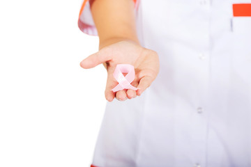 Young female doctor or nurse holding pink breast cancer