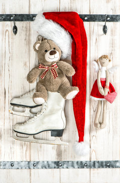 Red Santas hat, Teddy Bear, angel, ice skates. Christmas decorat