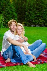 happy couple having picnic outdoor on a summer day