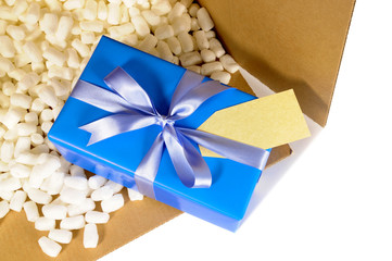 Cardboard shipping delivery box top open opened with blue christmas or birthday gift inside and...