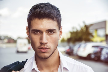 Attractive young man's headshot in urban environment 