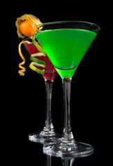 Two cocktails green and red cosmopolitan cocktails decorated wit