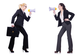 Two businesswomen holding loudpspeakers isolated on white