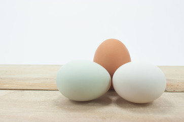 Still Life- eggs laid on a wooden white background.