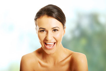 Portrait of nude woman laughing loud