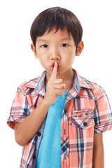 Fototapeta premium cute asian boy with his finger over her mouth, hushing.