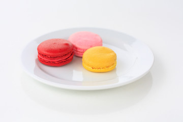 Sweet and colourful french macarons on white table