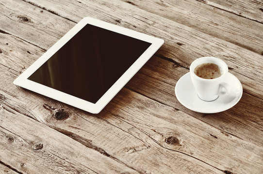 White tablet computer with cup coffe
