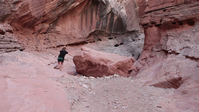 Young woman hiking narrow desert slot canyon HD 1594