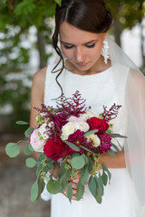 Beautiful bride outdoors with a bouquet