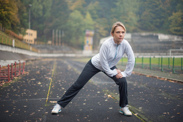 Woman exercising in the stadium (small depth of field)