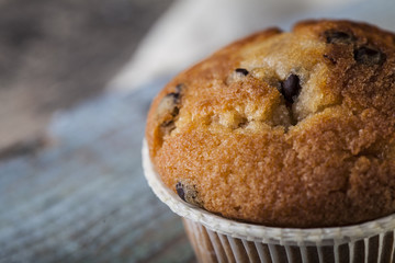 Chocolate muffin on a wooden background
