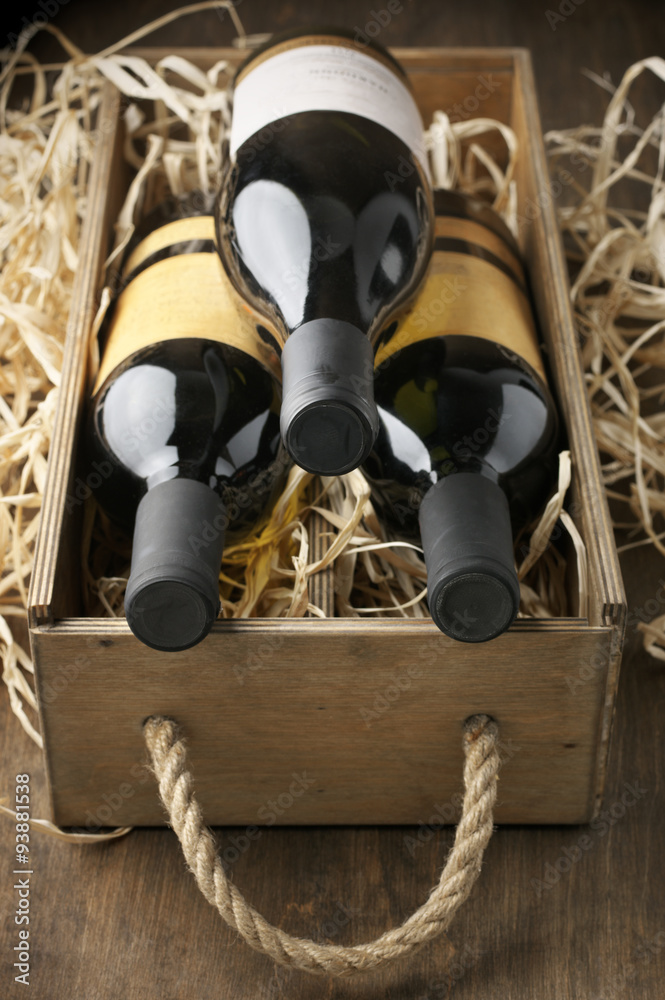 Poster Wine bottles in wooden box and straw