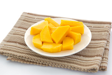 Mango slices in plate isolated on white background