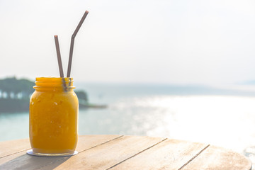 Mango juice with beautiful sea in background