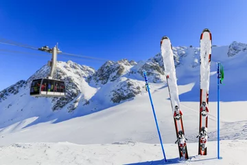 Abwaschbare Fototapete Winter season, ski equipments on ski run © Gorilla