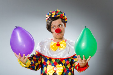 Clown with balloons in funny concept
