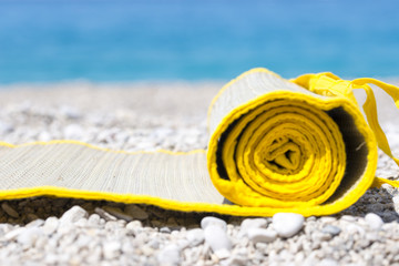 Straw mat, near the sea, on the beach.
