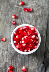 pomegranate seeds on wooden surface